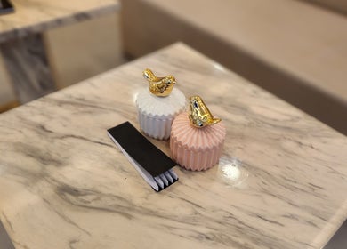 Elegant ceramic jars with golden bird decor on marble table at Kabayan Boracay, Malay, Western Visayas, PH.