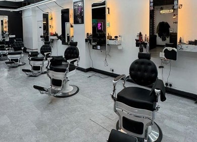 Sleek barber chairs and mirrors at Razortrim, Birmingham, England, GB, showcasing modern elegance and style.
