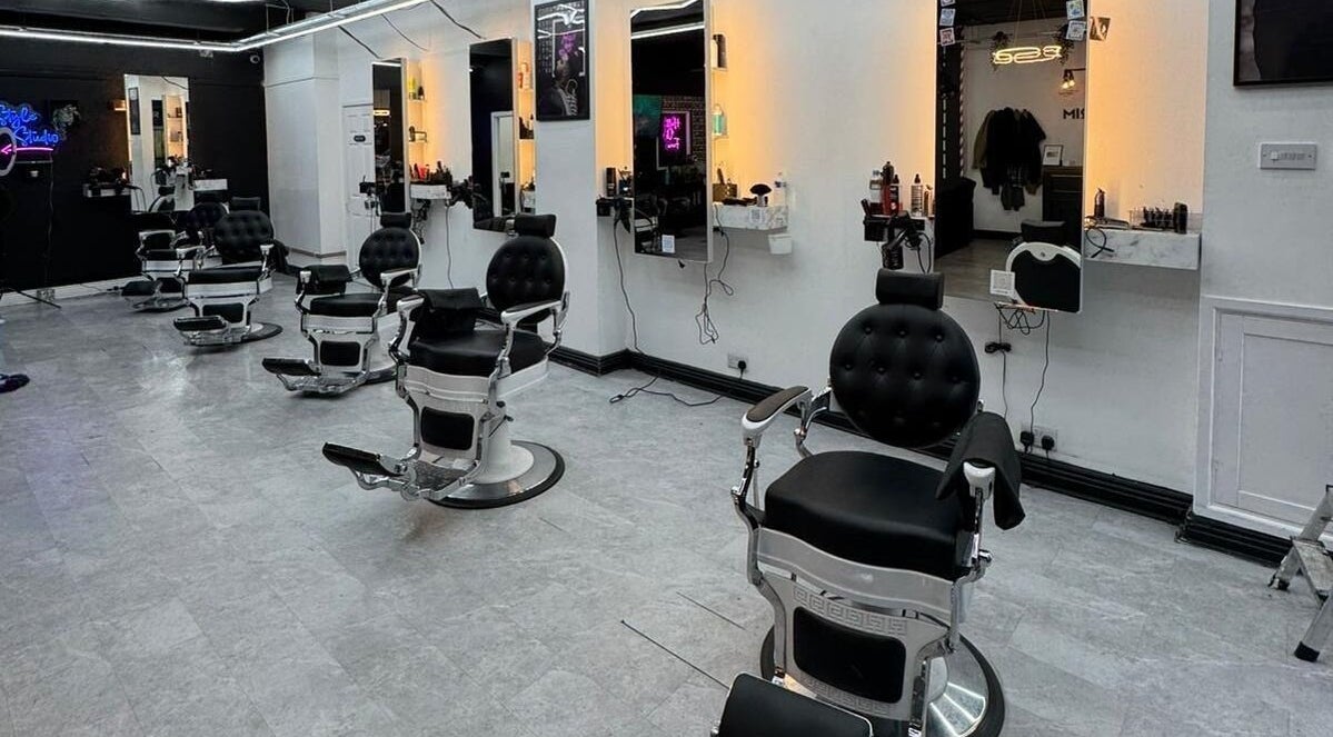 Sleek barber chairs and mirrors at Razortrim, Birmingham, England, GB, showcasing modern elegance and style.