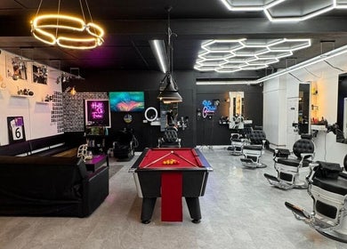 Modern interior of Razortrim in Birmingham, England, GB with stylish decor and barbershop chairs.