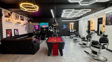 Modern interior of Razortrim in Birmingham, England, GB with stylish decor and barbershop chairs.