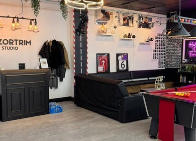 Stylish interior of Razortrim, Birmingham, England, GB. Features a pool table, seating, and decor for a welcoming atmosphere.