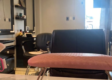 Sleek salon interior at Sage Blair Beauty, San Fernando, TT, showcasing elegant chairs and beauty tools.