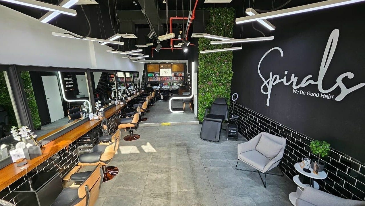 Modern interior of Spirals Salon in Dubai, AE featuring styling stations and chic decor.