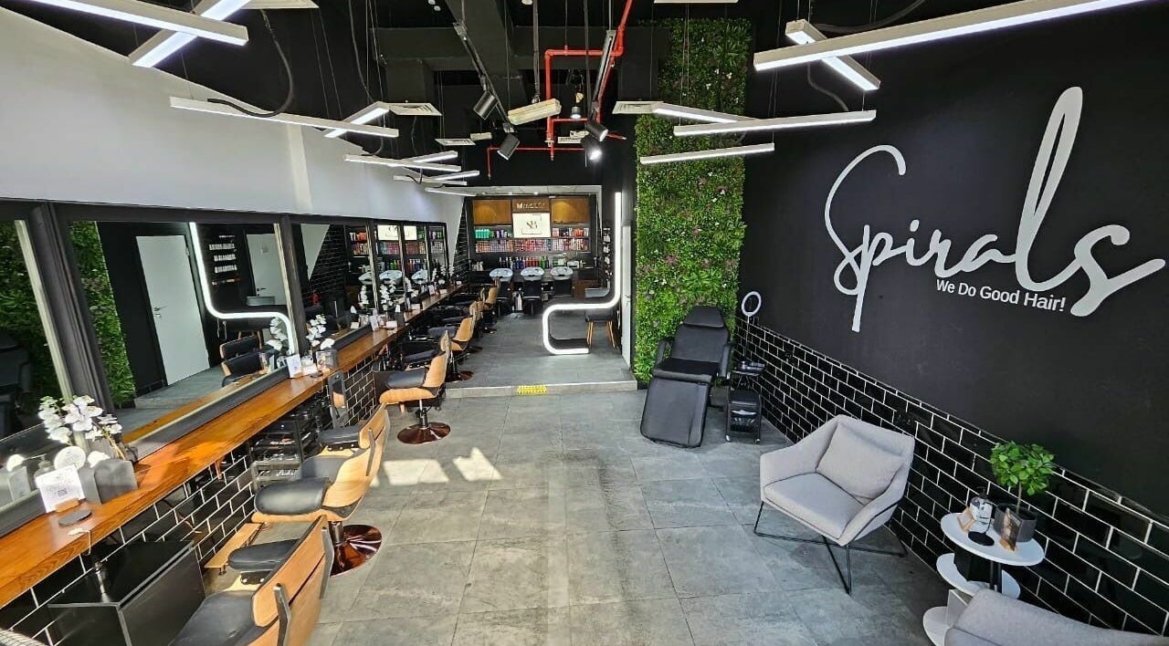 Modern interior of Spirals Salon in Dubai, AE featuring styling stations and chic decor.