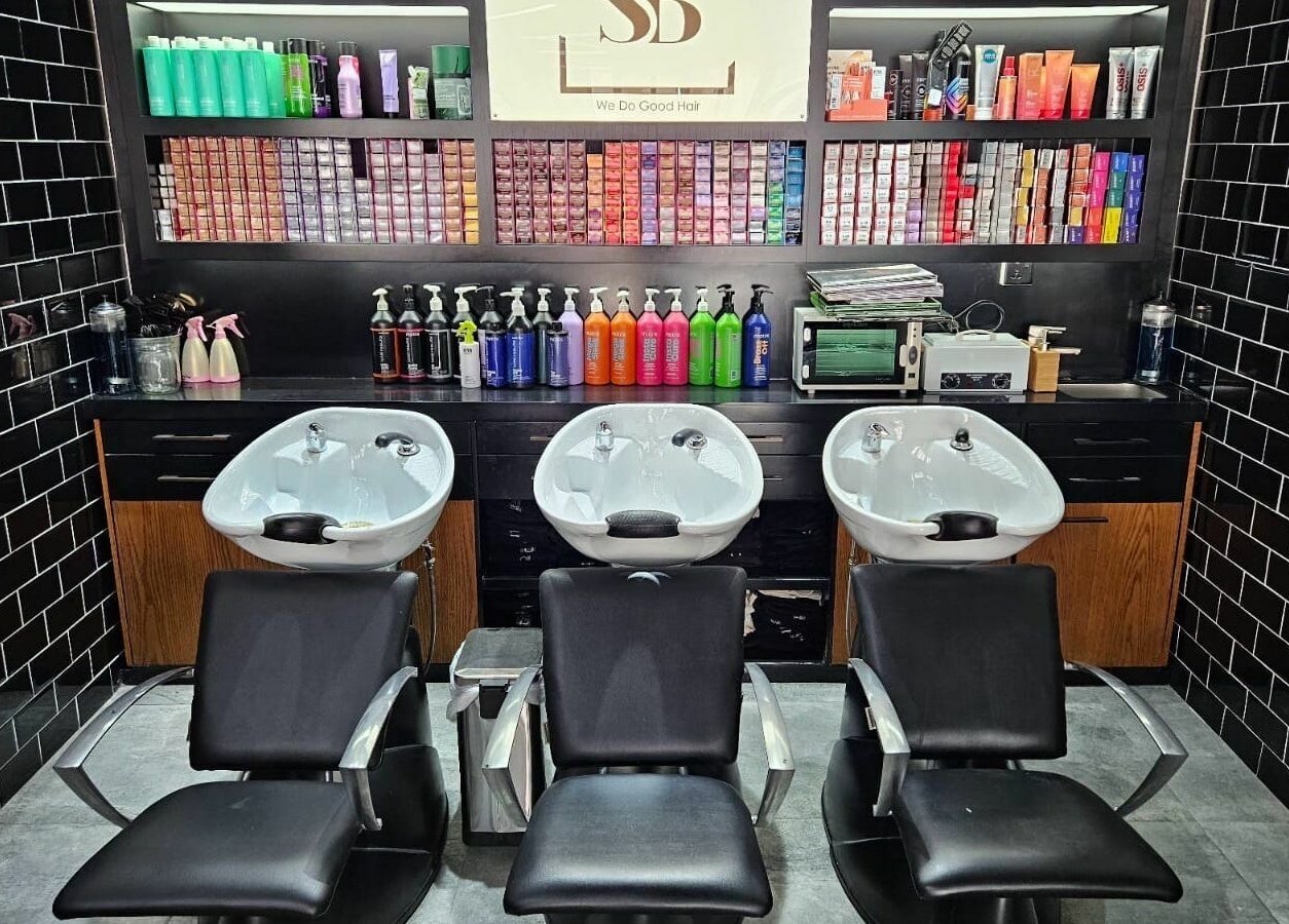 Luxurious hair wash stations at Spirals Salon in Dubai, AE featuring sleek black chairs and stylish design.