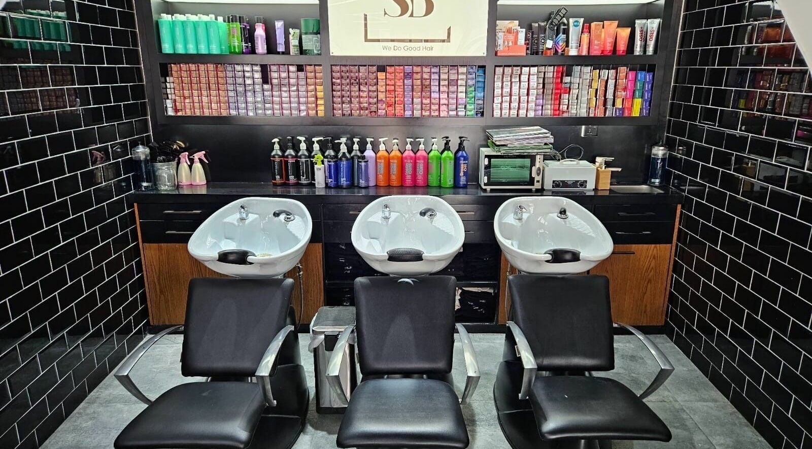 Luxurious hair wash stations at Spirals Salon in Dubai, AE featuring sleek black chairs and stylish design.