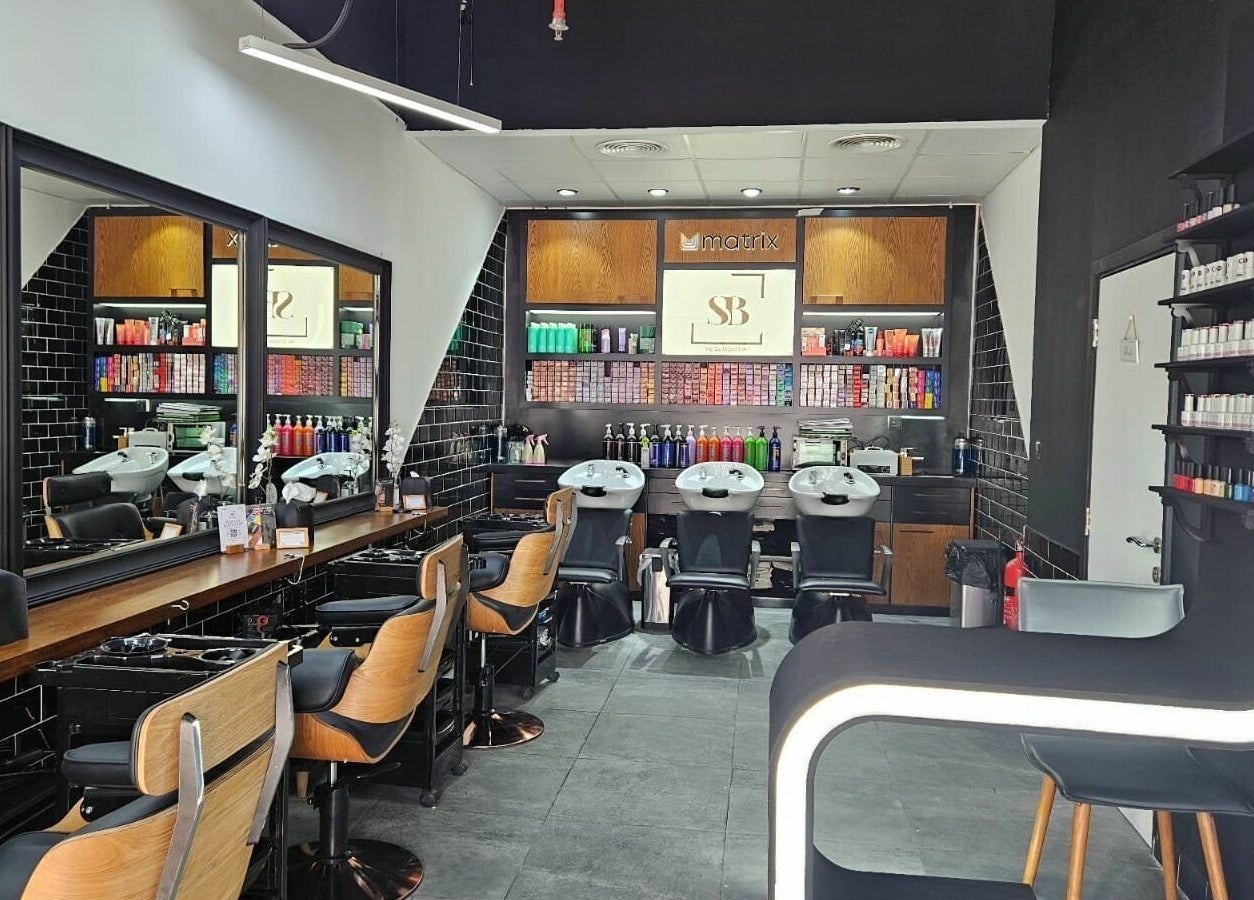 Modern interior of Spirals Salon in Dubai, AE featuring stylish hair stations and vibrant product displays.