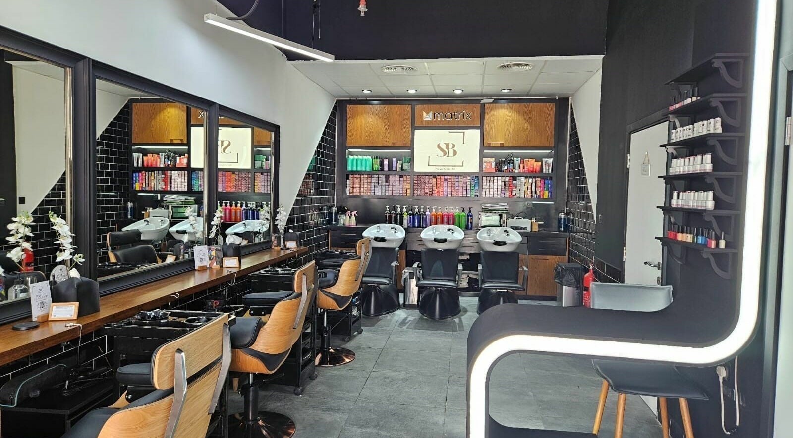 Modern interior of Spirals Salon in Dubai, AE featuring stylish hair stations and vibrant product displays.