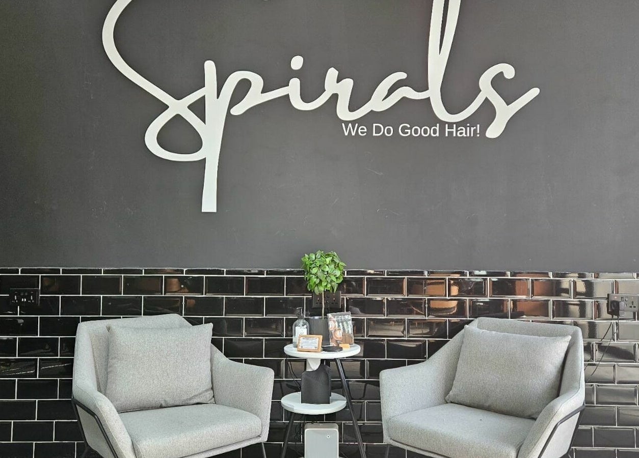 Inviting seating area at Spirals Salon, Dubai, AE, with modern chairs and sleek decor.