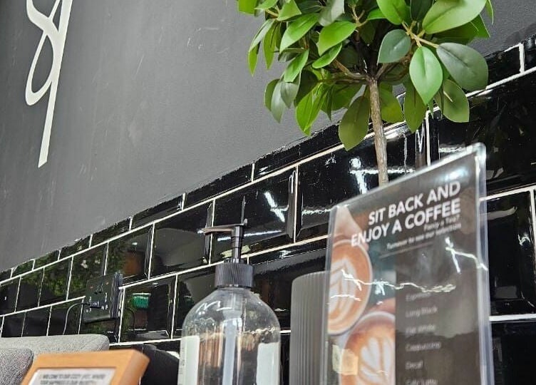 Chic cafe-style corner in Spirals Salon, Dubai, AE, with greenery and stylish decor.