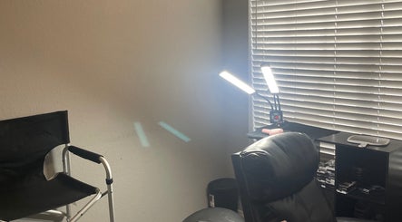 Cozy makeup station at Enhanced Beauty in Florida, Florida, US with chairs, lighting, and makeup tools.