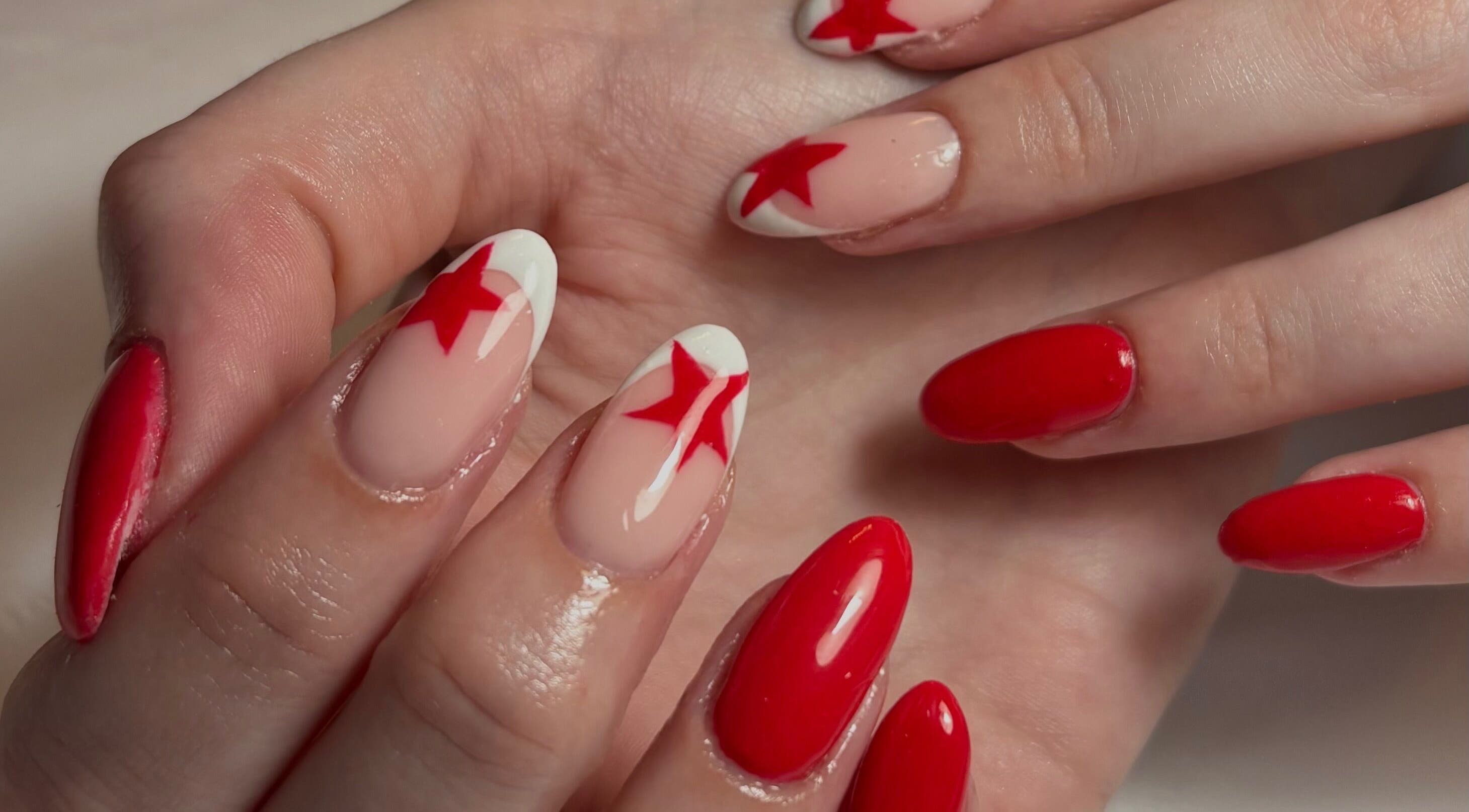 Red star nail art by Nailsby.S.B located in Worthing, England, GB. A chic and bold manicure design.