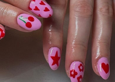 Stylish pink nails with red designs at Nailsby.S.B in Worthing, England, GB.