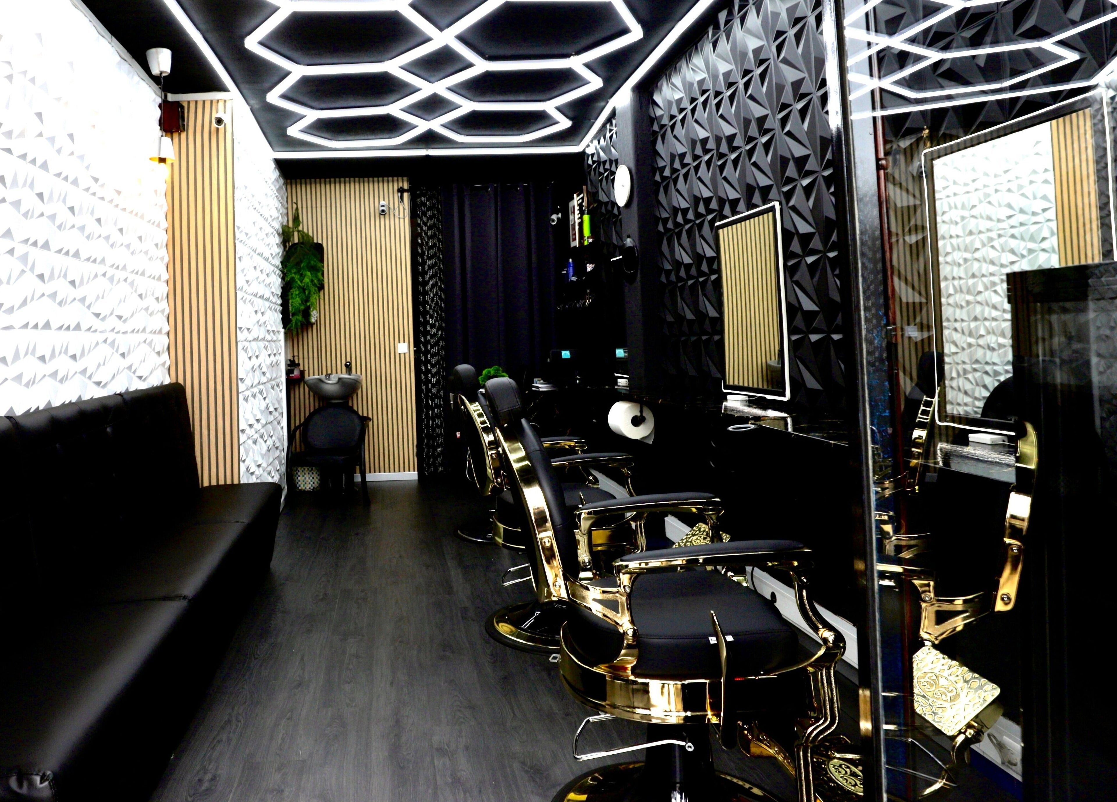 Interior of Sirius Barbershop Rato in Lisboa, PT, featuring sleek black and gold barber chairs and modern design.