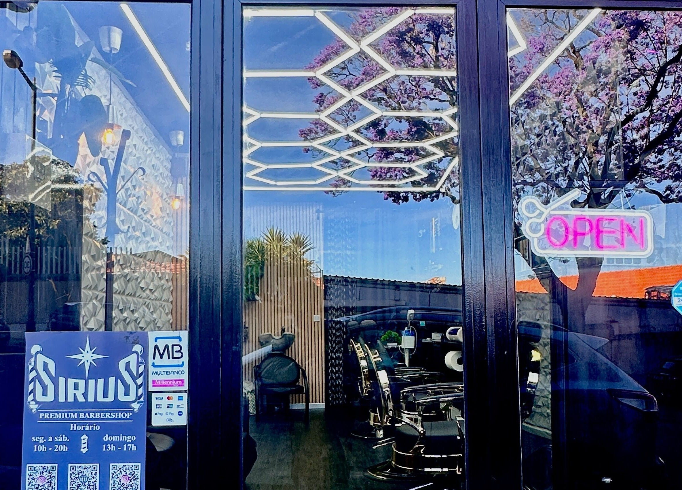 Sirius Barbershop Rato entrance with open sign and reflections in Lisboa, Lisboa, PT.