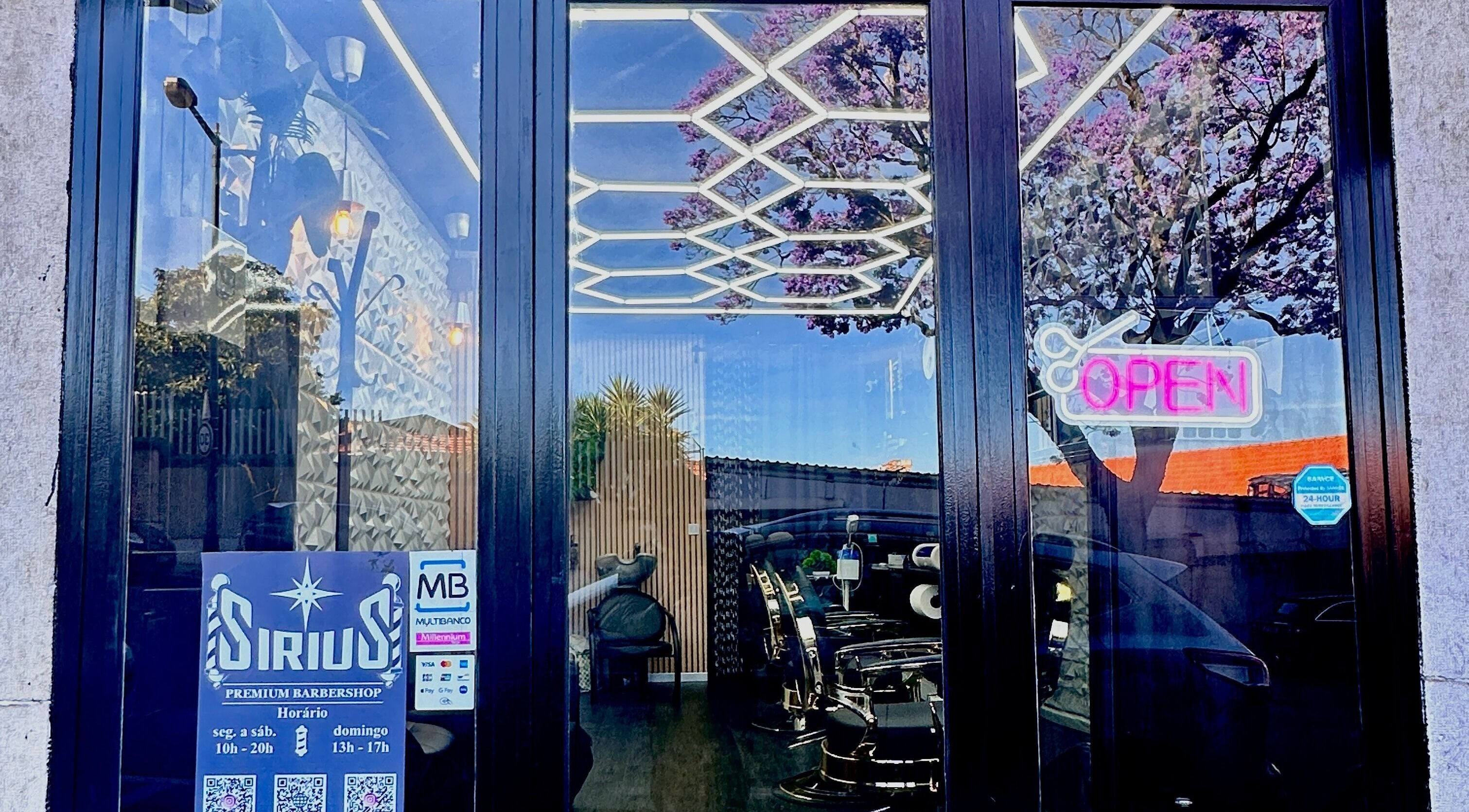 Sirius Barbershop Rato entrance with open sign and reflections in Lisboa, Lisboa, PT.