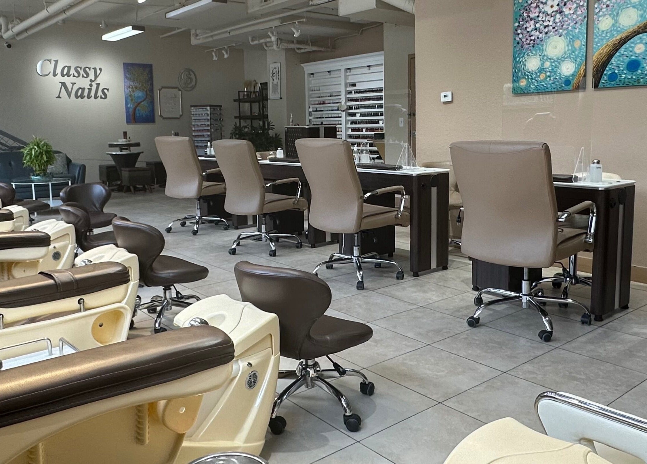 Interior view of Classy Nails salon in Denver, Colorado, US, featuring chic nail stations and elegant decor.