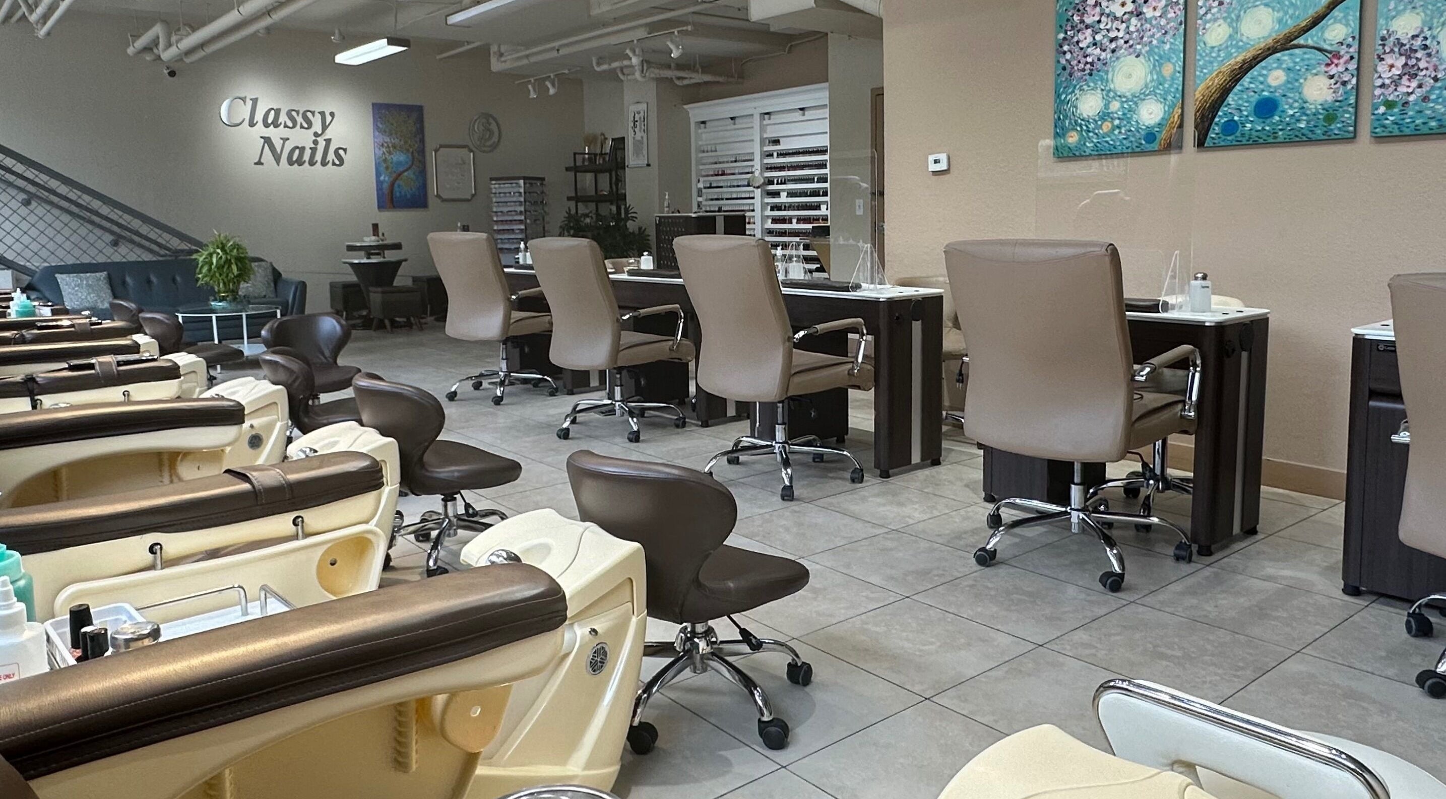 Interior view of Classy Nails salon in Denver, Colorado, US, featuring chic nail stations and elegant decor.