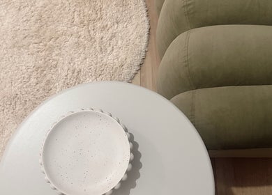 Elegant seating area at Eve Soleil, Dapto, New South Wales, AU, featuring a plush couch and decorative side table.