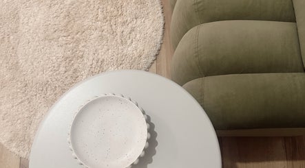 Elegant seating area at Eve Soleil, Dapto, New South Wales, AU, featuring a plush couch and decorative side table.