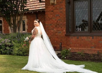 Bride in elegant gown at Eve Soleil garden venue, Dapto, New South Wales, AU.