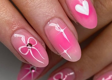 Elegant pink nail art with bows and hearts at Niamh & Michelle's Beauty Room, Ballineen, IE.