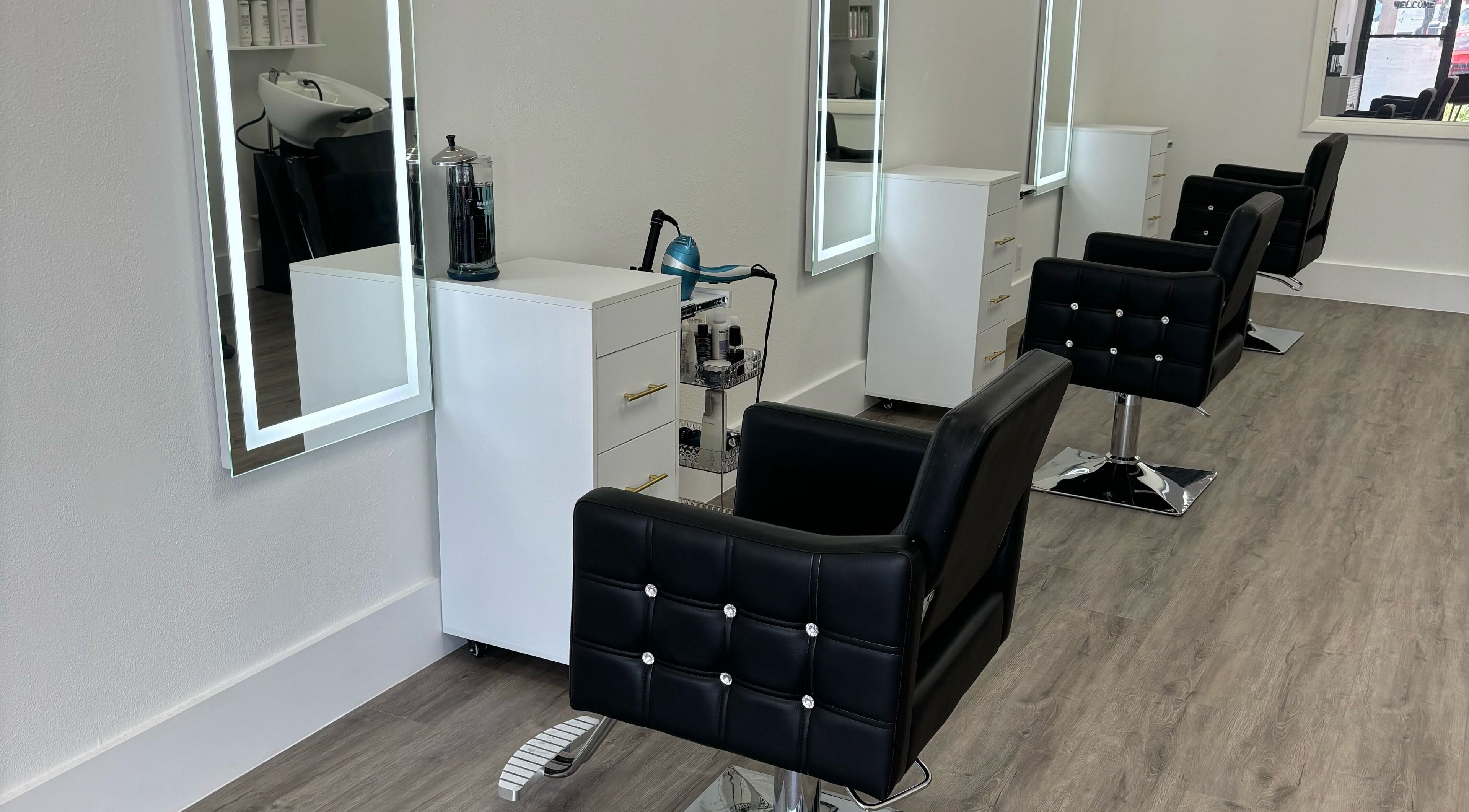 Modern styling chairs and mirrors at Platinum 954 Hair Salon, Oakland Park, Florida, US.