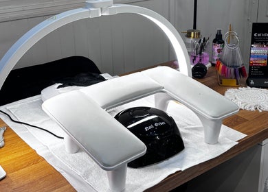 Manicure station at Nails by Evie, Plymouth, England, GB with nail art tools and UV lamp.