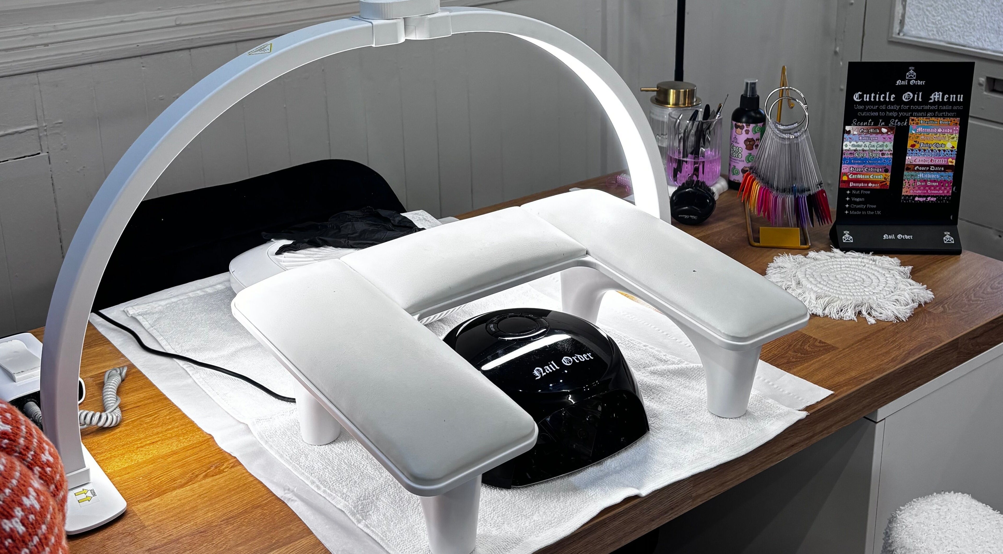 Manicure station at Nails by Evie, Plymouth, England, GB with nail art tools and UV lamp.