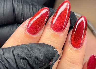 Elegant red nail art at Nails by Evie, Plymouth, England, GB accentuated by glossy finish.