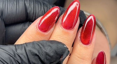 Elegant red nail art at Nails by Evie, Plymouth, England, GB accentuated by glossy finish.
