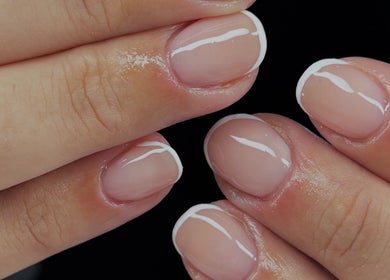 Elegant French manicure by Nails by Evie in Plymouth, England, GB showcasing glossy, well-groomed nails.