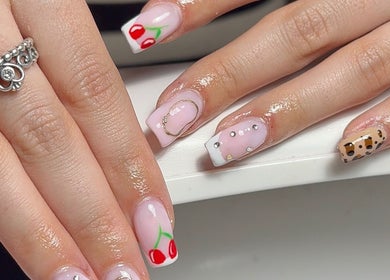 Stylish nail art featuring cherry and geometric designs at Nails by Eils, Kirkcaldy, Scotland, GB.
