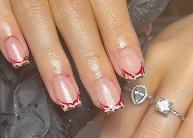 Stylish nail art with leopard and red accents at Nails by Eils, Kirkcaldy, Scotland, GB.