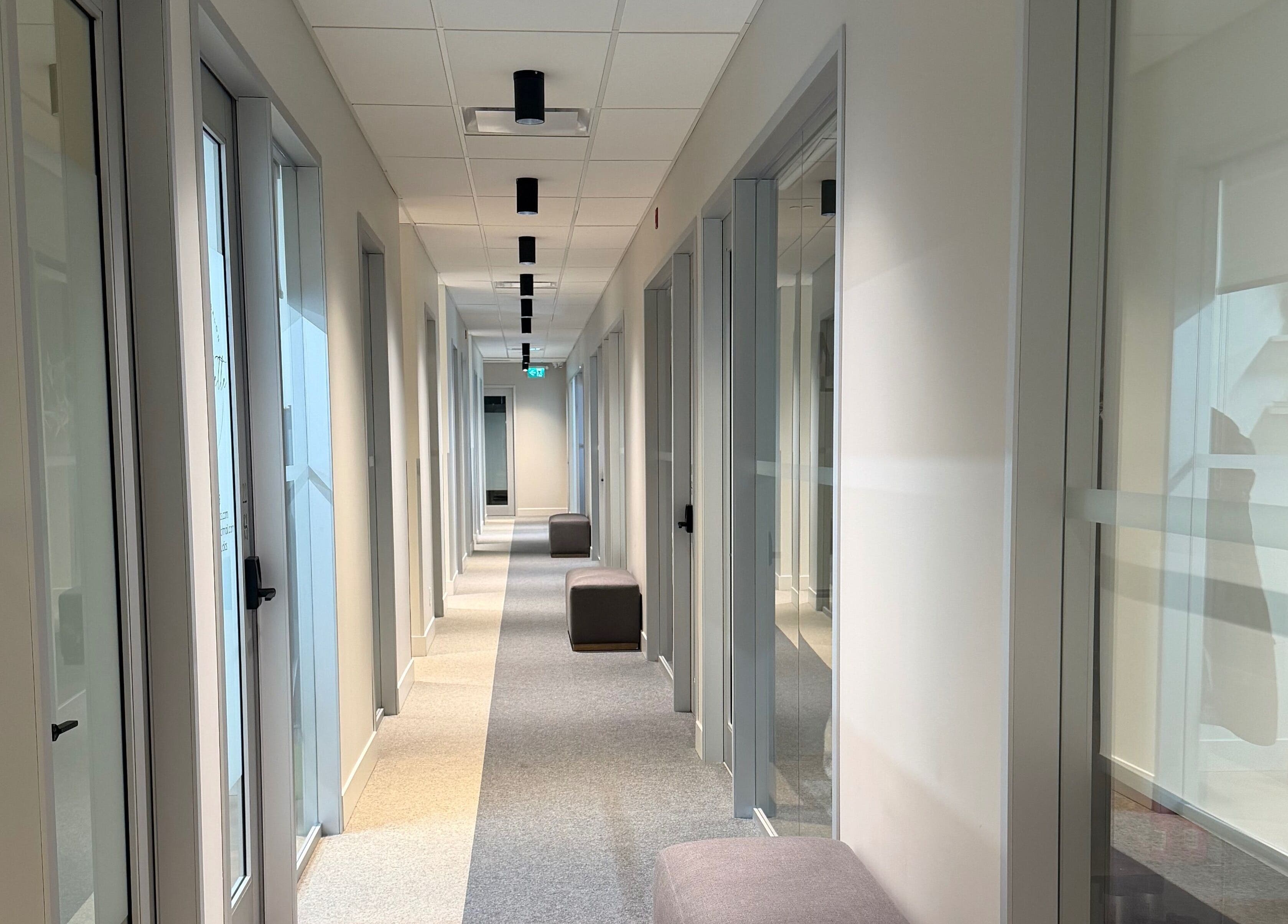 Modern hallway at Bynndll, Ajax, Ontario, CA, with sleek doors and soft lighting.