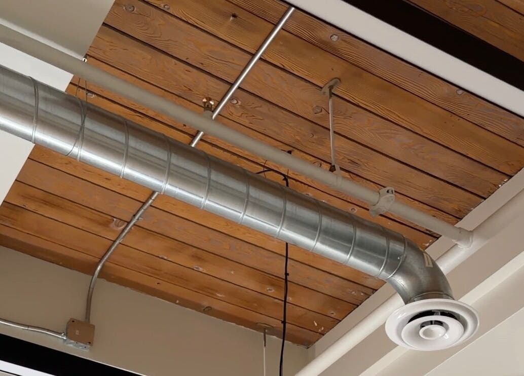 Exposed ductwork and wooden beams at Bynndll venue in Ajax, Ontario, CA showcasing industrial chic design.