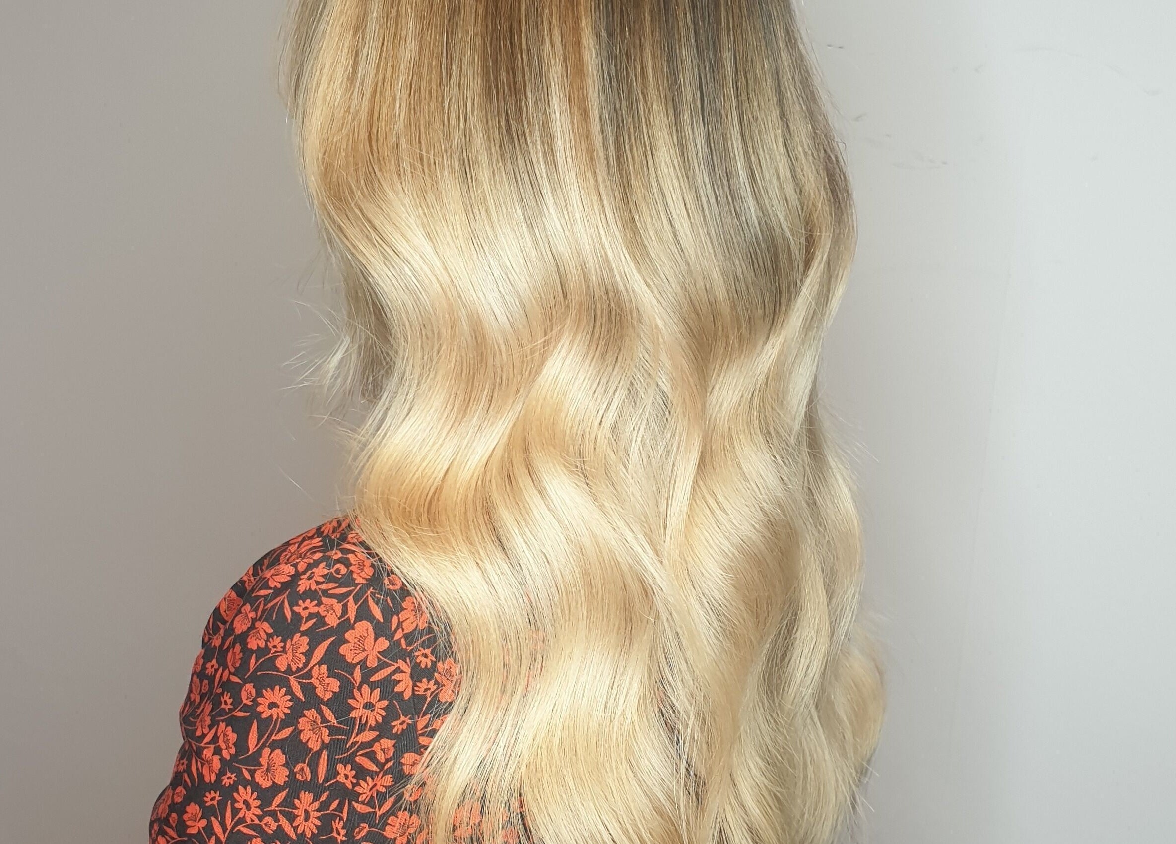Blonde wavy hair styled at Louise Frances in Derby, England, GB, showcasing a natural, elegant look.