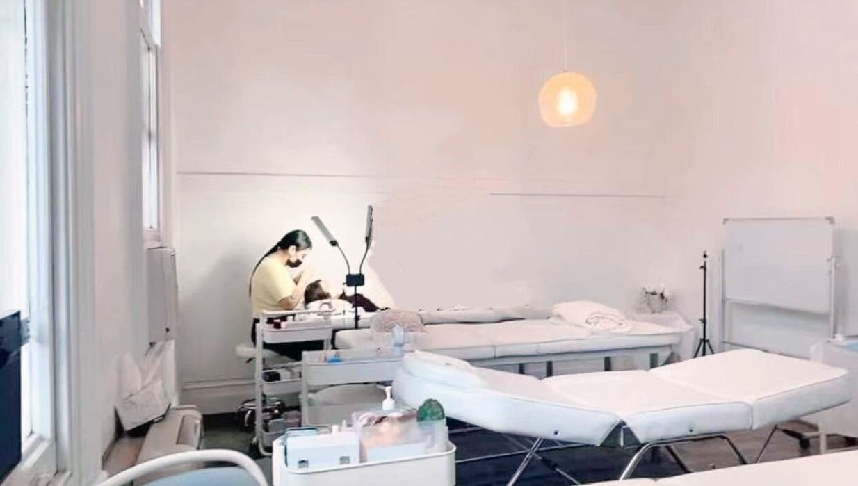 Lashqueencoco CBD's serene lash treatment room in Melbourne, Victoria, AU with a specialist and client.