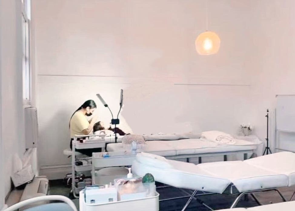 Lashqueencoco CBD's serene lash treatment room in Melbourne, Victoria, AU with a specialist and client.