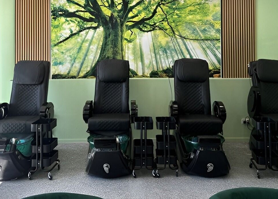 Chic pedicure chairs at D.T Nails Spa Yarrabilba in Yarrabilba, Queensland, AU under a lush tree mural.