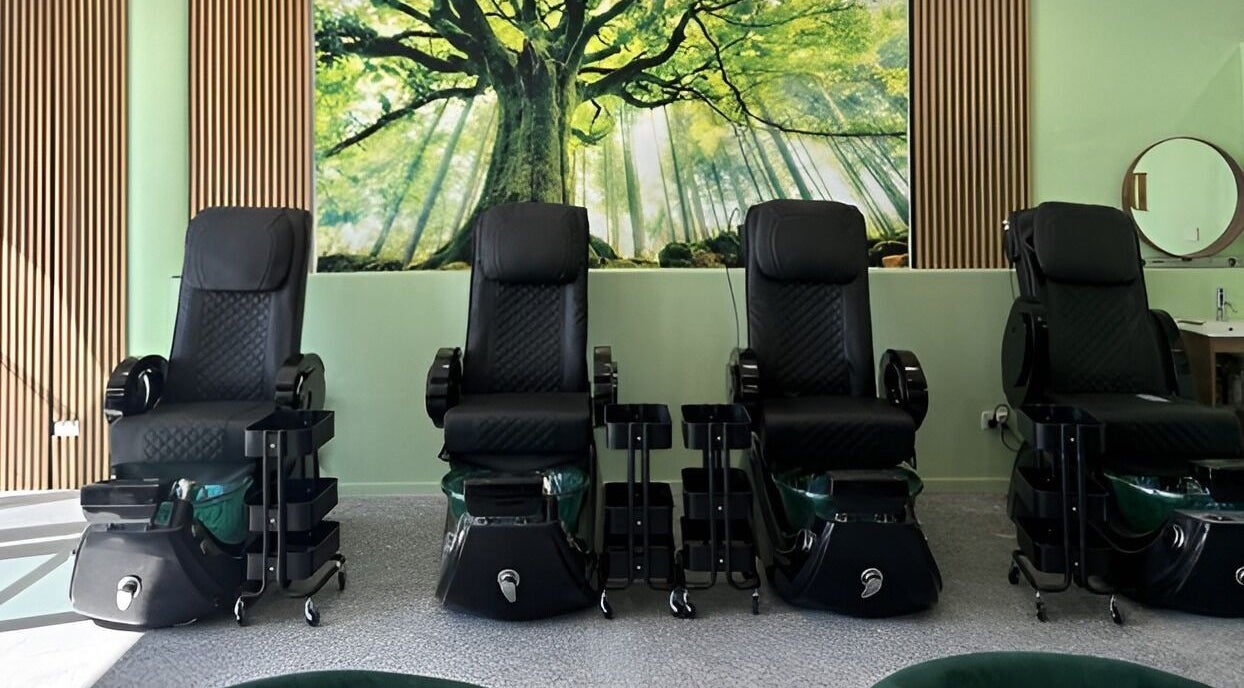 Chic pedicure chairs at D.T Nails Spa Yarrabilba in Yarrabilba, Queensland, AU under a lush tree mural.