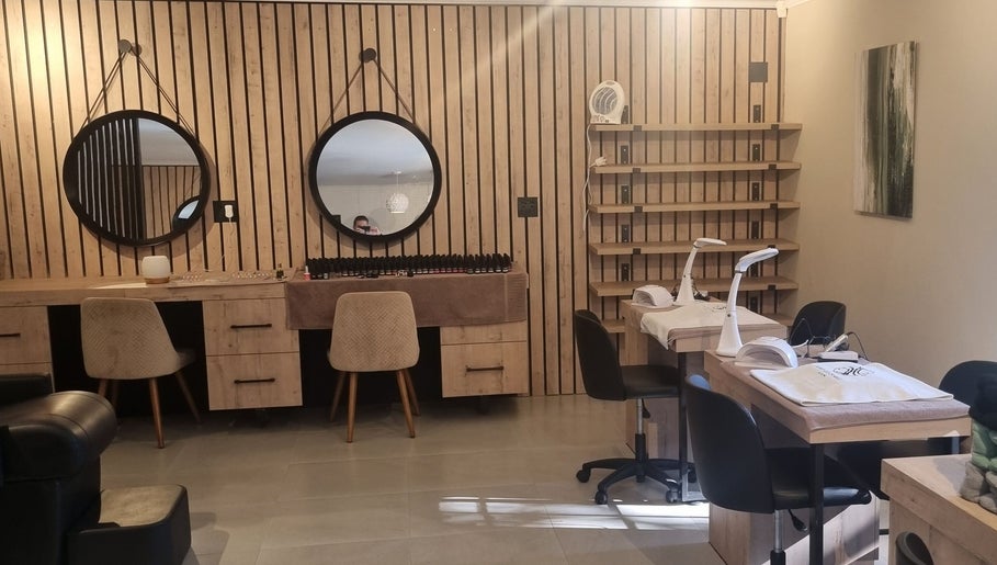 Modern nail salon at Sweet Escape Beauty, Sandton, Gauteng, ZA, featuring stylish wooden decor and round mirrors.