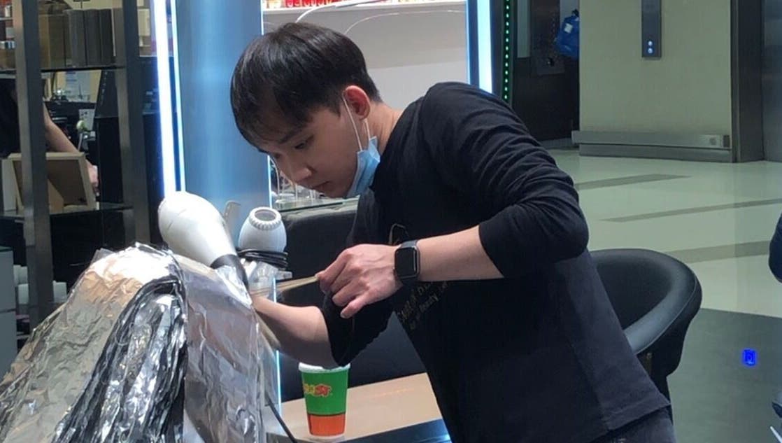 Stylist at Hair by Clement, Sydney, New South Wales, AU, expertly working on hair treatment.