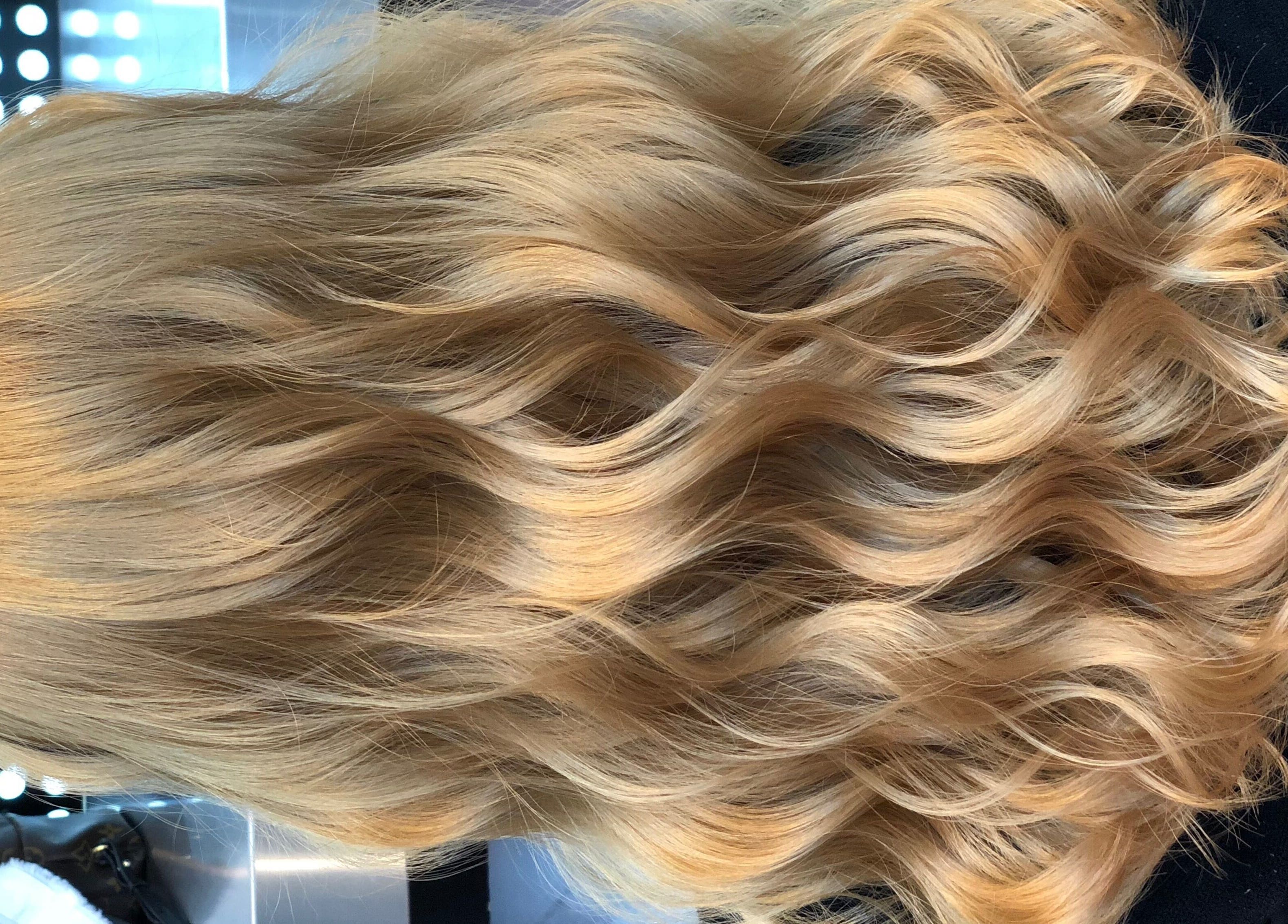 Elegant wavy blonde hair styled at Hair by Clement in Sydney, New South Wales, AU.