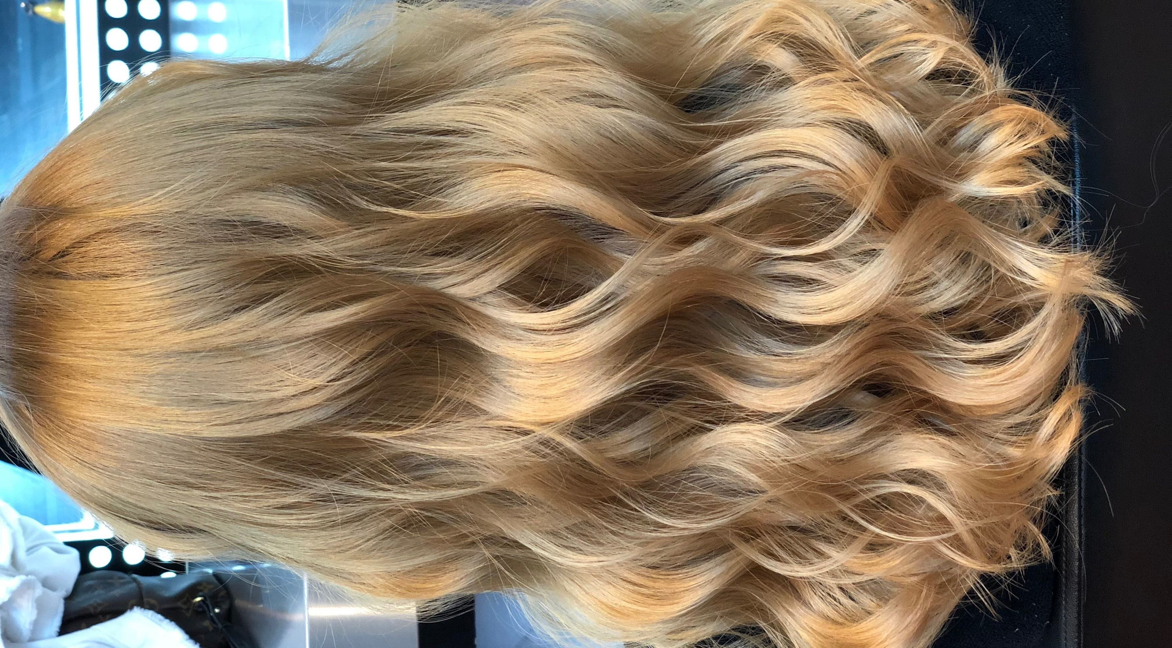 Elegant wavy blonde hair styled at Hair by Clement in Sydney, New South Wales, AU.
