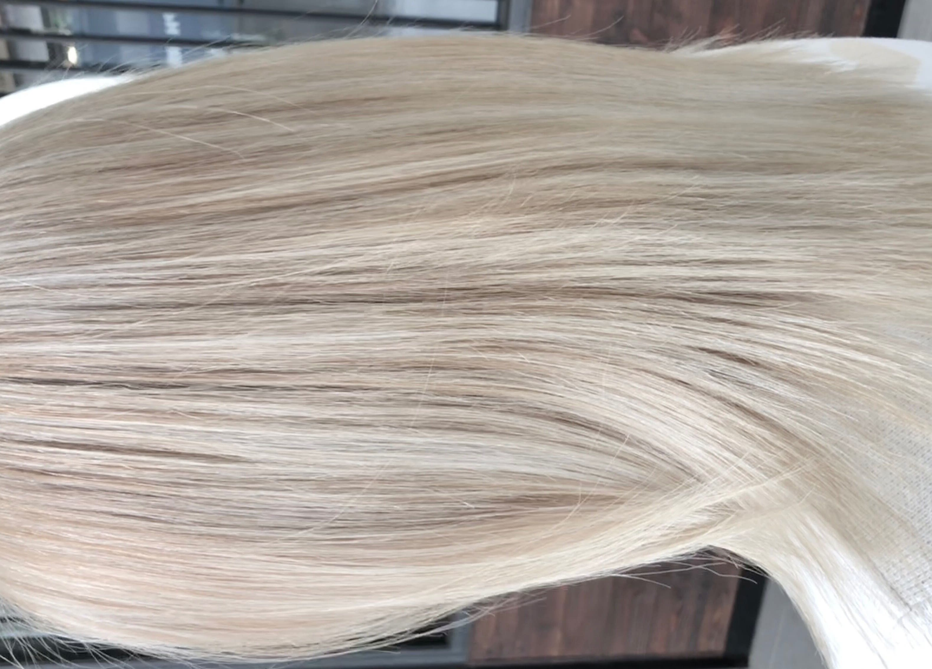 Silky blonde hair styled at Hair by Clement in Sydney, New South Wales, AU, showcasing expert hair coloring.