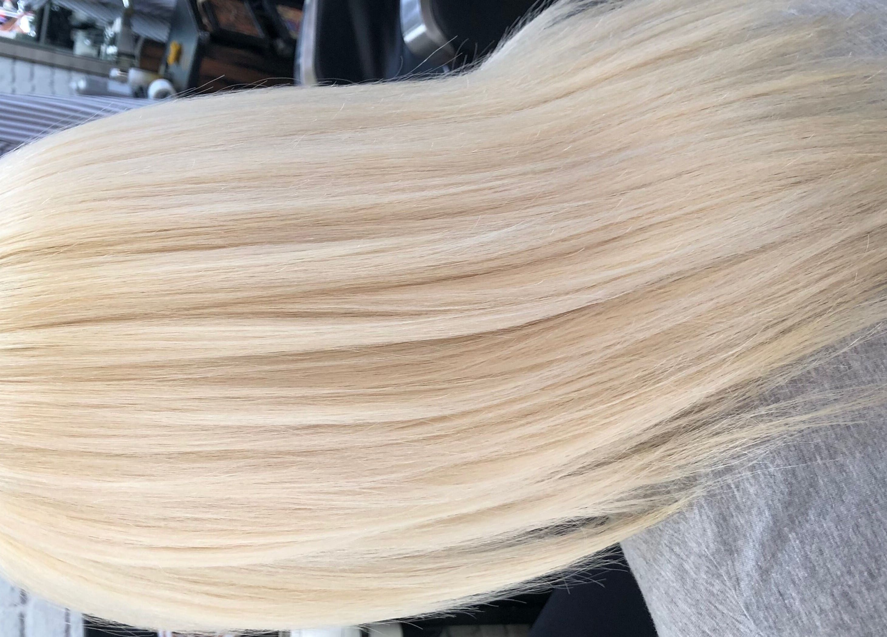 Elegant silky blonde hair styled at Hair by Clement, Sydney, New South Wales, AU, showcasing smooth texture.