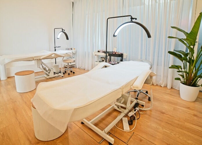 Elegant treatment room at The Lash Squad, Melbourne, Victoria, AU with modern chairs and serene decor.
