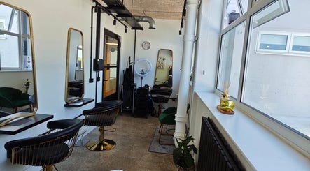 Stylish interior of Louis Does Hair salon, London, England, GB with modern decor and elegant mirrors.